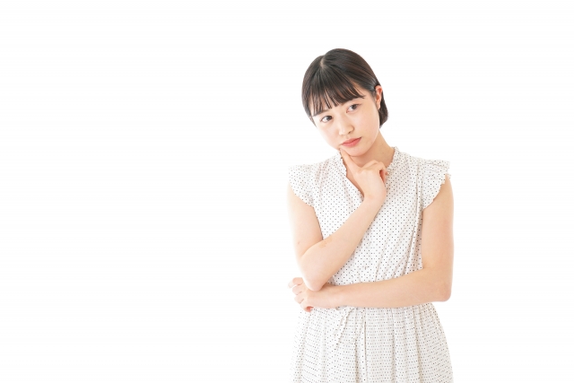 結婚相談所埼玉　白いワンピースを着た若い女性が一人で悩んでいる画像です。