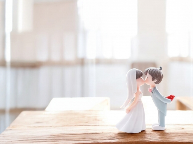 結婚相談所埼玉　とても可愛らしい新郎新婦の人形が教会でキスをしているイラストです。